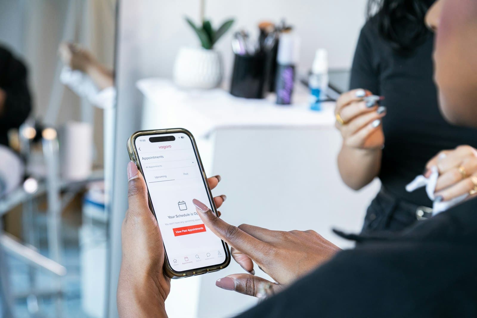 En hand håller en mobil med en bokningsapp öppen